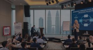 A confident Malay lady giving a speech at a training workshop